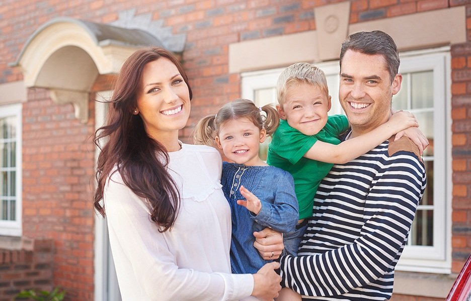 Smiling young family outside