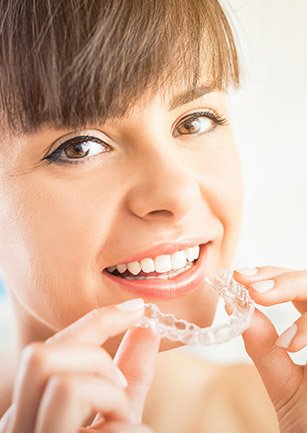 Woman placing ClearCorrect aligner