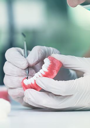 Closeup of dentist working on denture