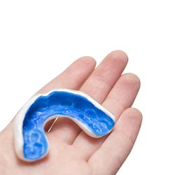 person holding mouthguard