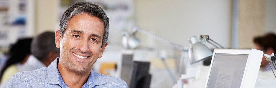 Man smiling at business office