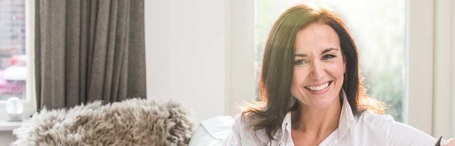 Relaxed woman smiling on couch