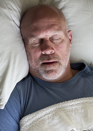 Man sleeping soundly in bed