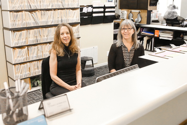 Two team members behind reception desk