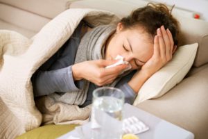 woman lying in bed sick medication