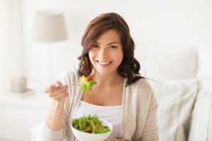 Woman eating green salad