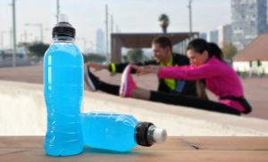 people working out with sports drinks