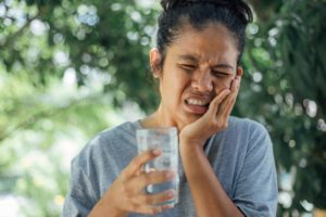 person with sensitive teeth in pain 