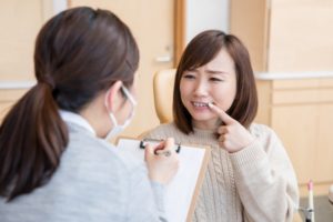 Woman asking Cambria dentist questions at dental checkup