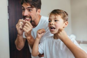 father and son flossing together