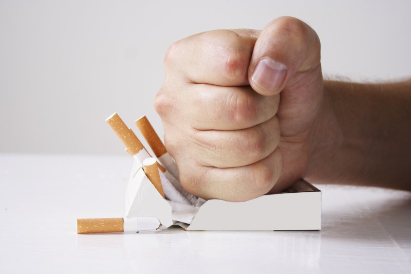 Hand crushing cigarettes