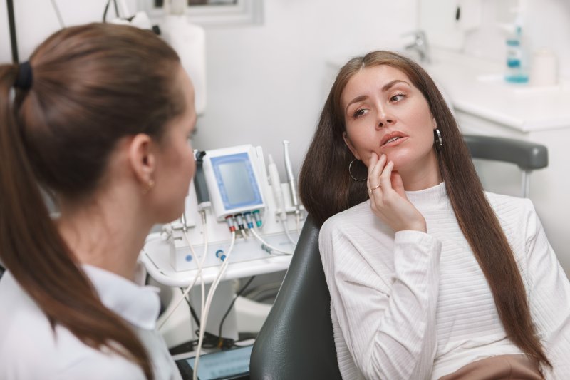 A good emergency dentist treating her female patient